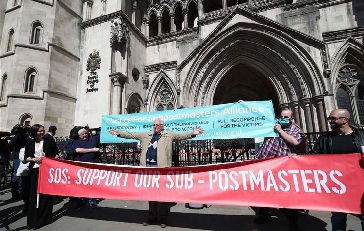 Sub-postmasters highlighting their case outside the Law Courts in London